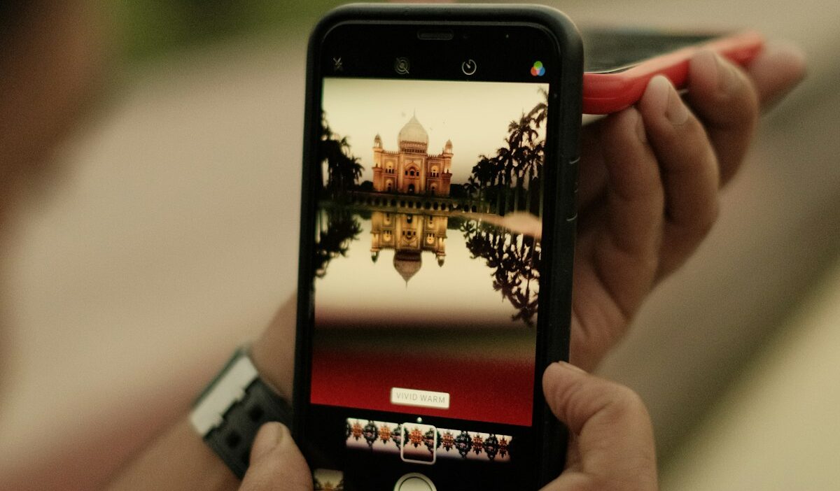 Smartphone showing in-feed native ad blending seamlessly into article stream, illustrating mobile-native yield optimization technique
