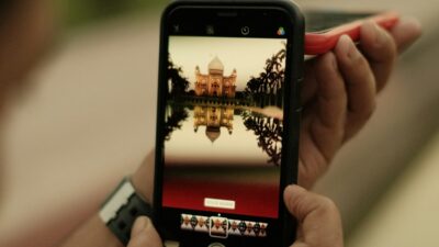 Smartphone showing in-feed native ad blending seamlessly into article stream, illustrating mobile-native yield optimization technique